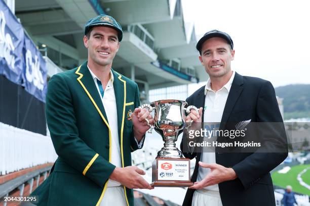 Pat Cummins of Australia and Tim Southee of New Zealand pose with the test series trophy during a nets session ahead of the First Test in the series...
