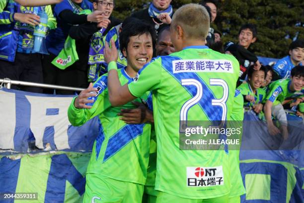 Toshiki Ishikawa of Shonan Bellmare celebrates with teammates Andre Bahia and Kaoru Takayama after scoring the team's second goal during the J.League...