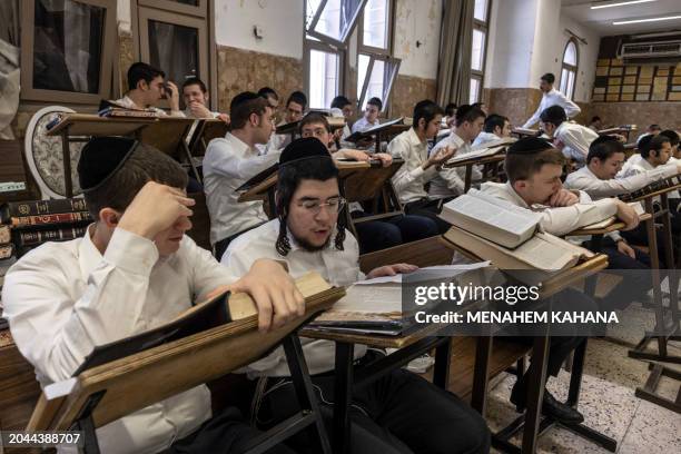 Ultra-Orthodox Jewish students study the Torah at the Ponevezh Yeshiva in the central Israeli city of Bnei Brak on February 27, 2024. As Israelis are...