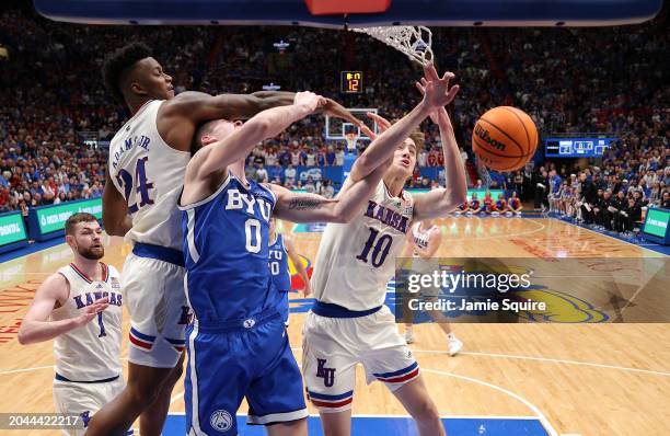 Noah Waterman of the Brigham Young Cougars competes with Johnny Furphy and K.J. Adams Jr. #24 of the Kansas Jayhawks fro a rebound during the 1st...