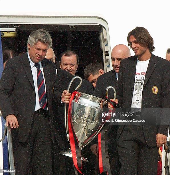 Milan football coach Carlo Ancelotti and captain Paolo Maldini arrive home with the Champions League Trophy at Malpensa International Airport on May...