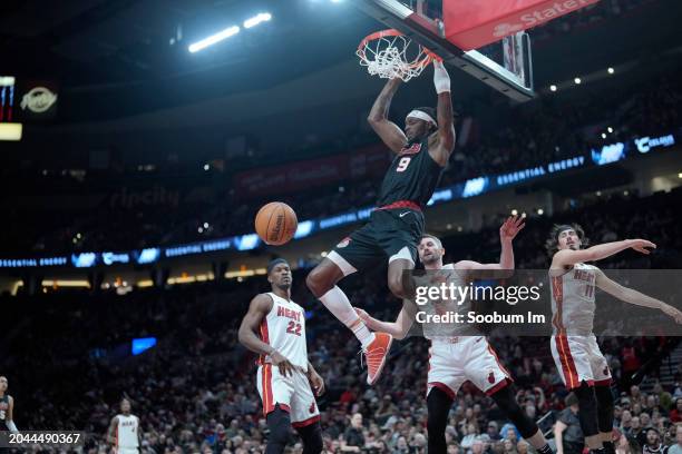 Jerami Grant of the Portland Trail Blazers dunks the ball over Kevin Love of the Miami Heat during the first half at Moda Center on February 27, 2024...