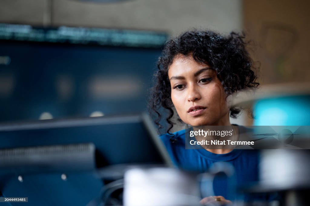 Data Analysis and Protect Insights to Improve Your Business Process with Software Development. A female software engineer on software project development to analyzing and ensuring reliability in a tech business office.