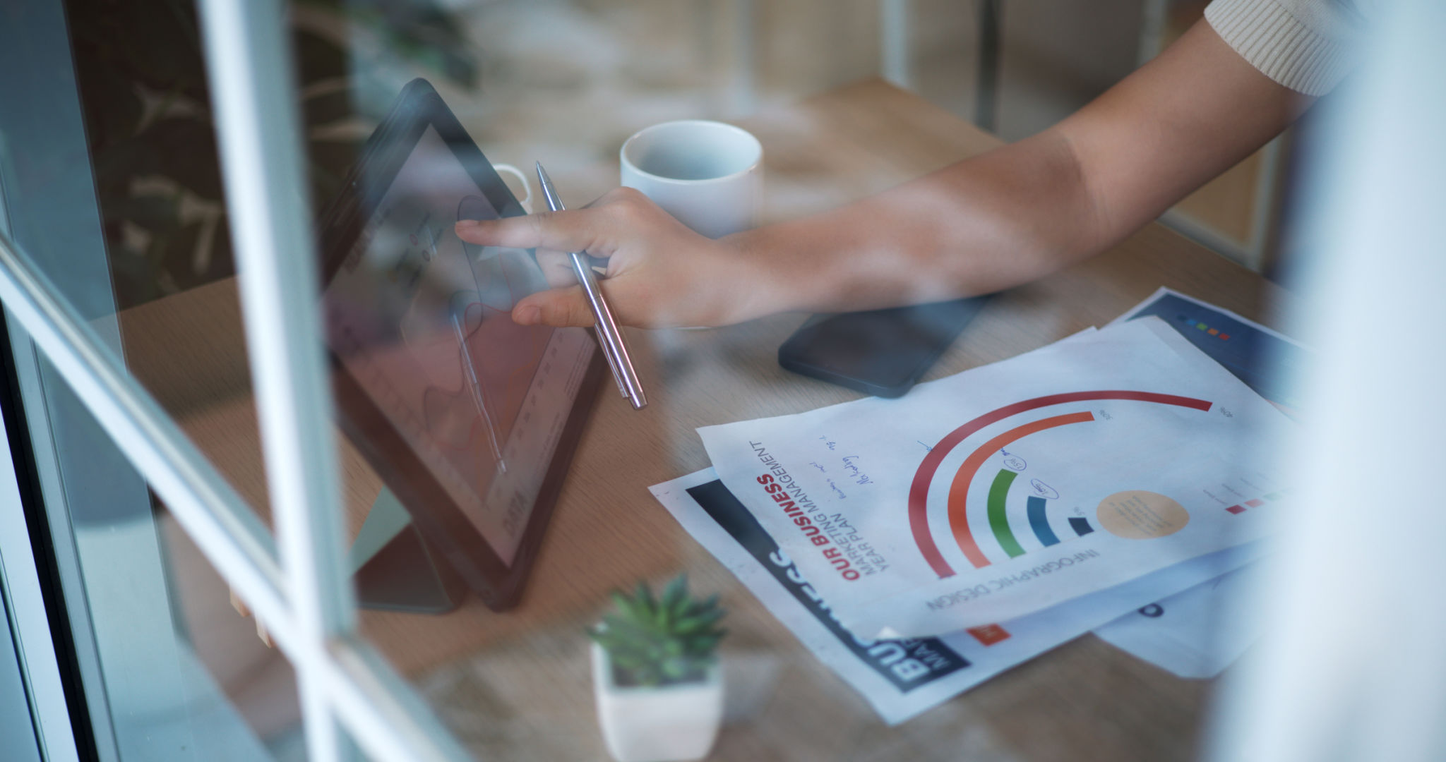Two young women learning financial investing through internet on tablet Two young women learning financial investing through internet on tablet