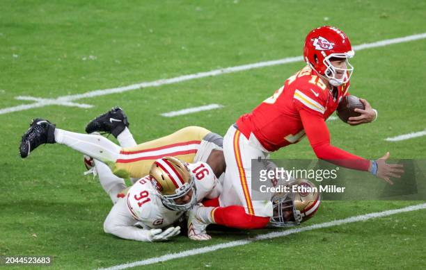 Quarterback Patrick Mahomes of the Kansas City Chiefs is tackled after a 3-yard run by defensive end Arik Armstead and defensive tackle Javon...