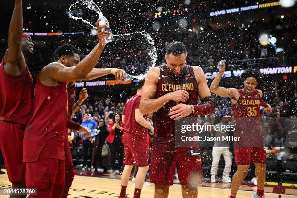 Max Strus of the Cleveland Cavaliers is showered with water by his teammates after hitting a half-court buzzer-beater to defeat the Dallas Mavericks...