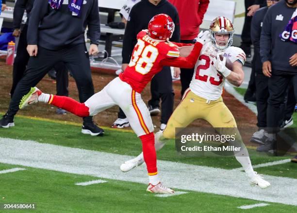 Running back Christian McCaffrey of the San Francisco 49ers is pushed out of bounds by cornerback L'Jarius Sneed of the Kansas City Chiefs after a...