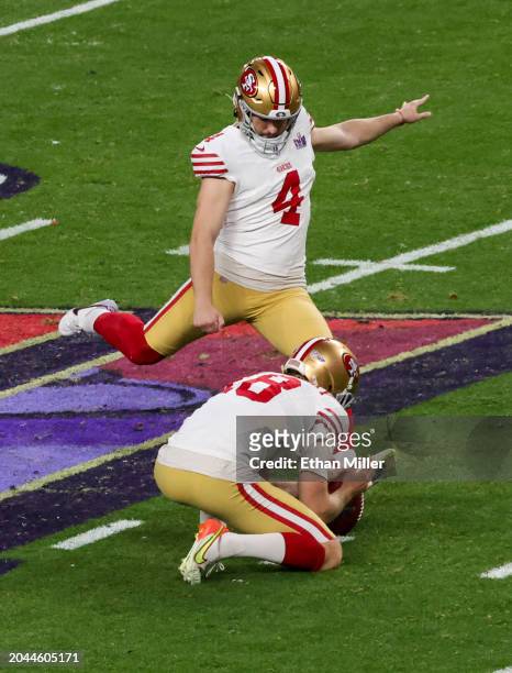 Punter Mitch Wishnowsky of the San Francisco 49ers holds as place kicker Jake Moody kicks a 27-yard field goal against the Kansas City Chiefs in...