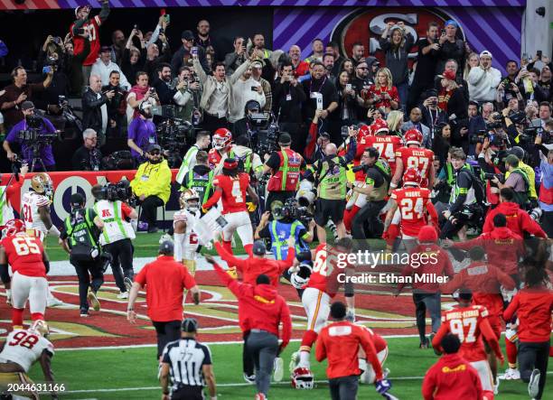 The Kansas City Chiefs celebrate after quarterback Patrick Mahomes hit wide receiver Mecole Hardman Jr. #12 on a 3-yard touchdown pass in overtime...