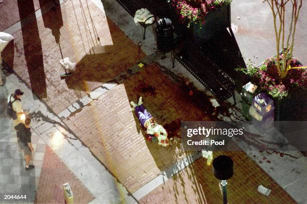 The body of one of the victims lies on ground following the bomb explosion at the AT&T Pavillion in the Centennial Olympic Park during the 1996...