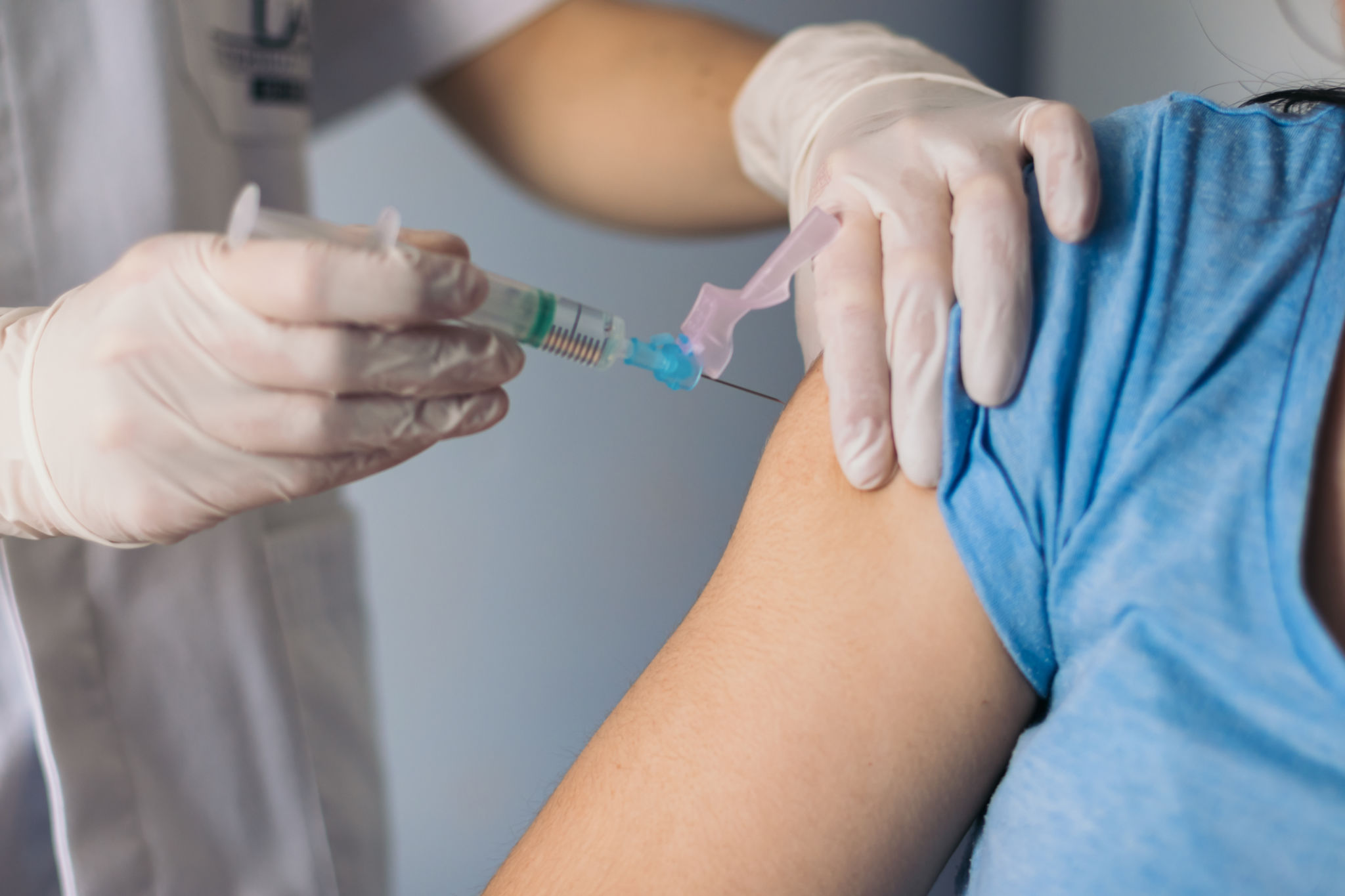 nurse giving a vaccine to a patient. Close-up nurse giving a vaccine to a patient. Close-up