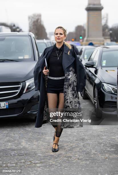 Christine Wuerfel-Stauss wears net leggings, black shorts, coat with graphic print, polo shirt outside Dior during the Womenswear Fall/Winter...