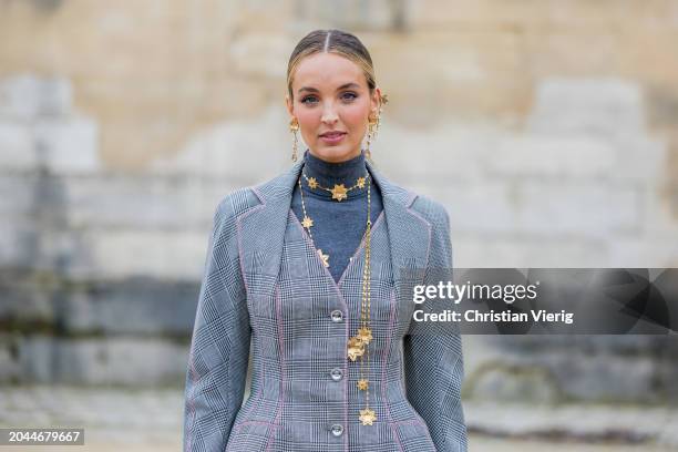 Guest wears grey tailored blazer, skirt with print outside Dior during the Womenswear Fall/Winter 2024/2025 as part of Paris Fashion Week on February...