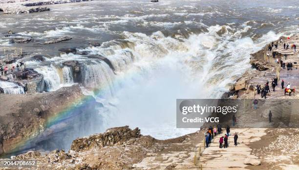 Aerial view of tourists viewing Hukou Waterfall on the Yellow River on February 27, 2024 in Yan'an, Shaanxi Province of China.