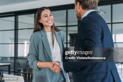 Business persons shaking hands across the table. Business persons shaking hands across the table.