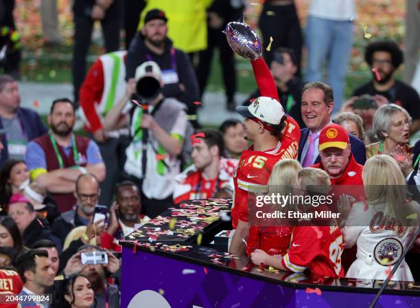 Quarterback Patrick Mahomes of the Kansas City Chiefs holds up the Vince Lombardi Trophy as head coach Andy Reid looks on as the Chiefs celebrates...