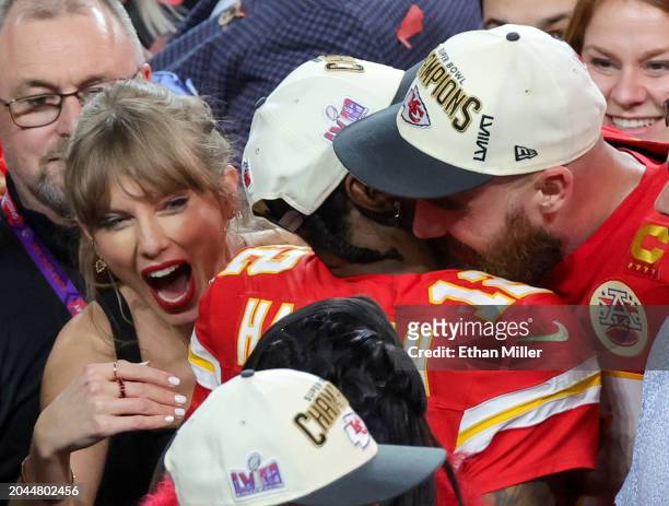 Taylor Swift, wide receiver Mecole Hardman Jr. #12 and tight end Travis Kelce of the Kansas City Chiefs celebrate after the Chiefs' 25-22 overtime...