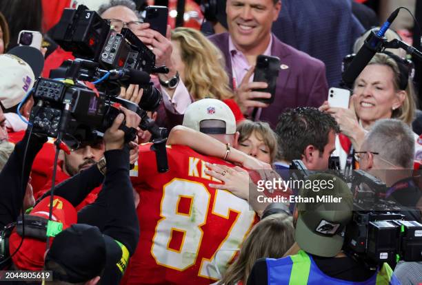 Tight end Travis Kelce of the Kansas City Chiefs hugs Taylor Swift as they celebrate the Chiefs' 25-22 overtime victory over the San Francisco 49ers...