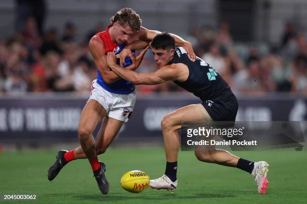 Adam Cerra of the Blues and Caleb Windsor of the Demons contest the ball during the 2024 AFL Community Series match between Carlton Blues and...
