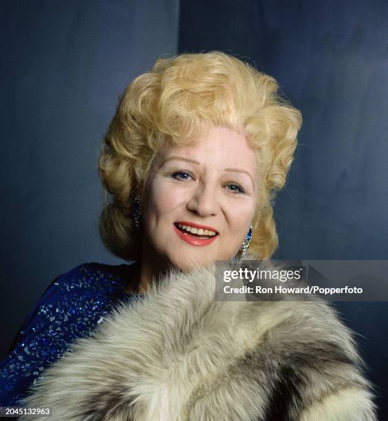 English singer Anne Shelton posed holding a fur coat in London circa 1970.