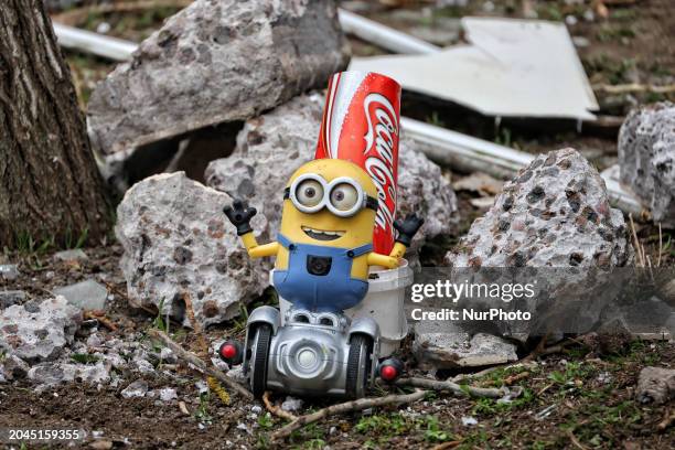 Minion toy and a Coca-Cola can are lying among the rubble in a section of a residential building that a Russian drone destroyed in Odesa, Ukraine, on...