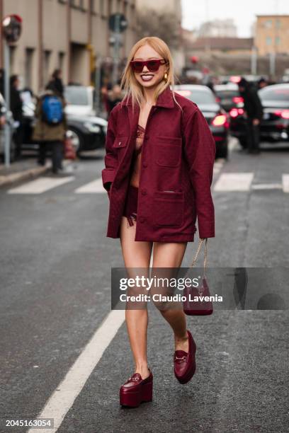 Niki Wu Jie wears burgundy Gucci sunglasses, burgundy Gucci jacket, burgundy lace top, burgundy Gucci platform loafers, burgundy Gucci bag, outside...