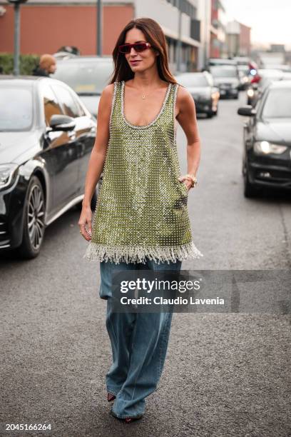 Gala Gonzalez wears green sequins mini dress, jeans,, burgundy Gucci sunglasses, burgundy heels, outside Gucci, during the Milan Fashion Week -...