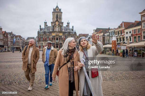 two middle aged diverse couples on staycation in delft - city breaks stock pictures, royalty-free photos & images