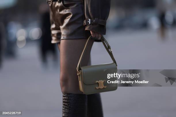 Justyna Czerniak seen wearing brown leather cropped jacket, matching brown leather shorts, black tights, Celine light green / khaki leather Triomphe...