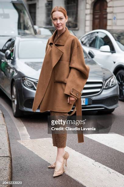 Cristiana Capotondi wears camel coat, brown pants, beige heels, outside Philosophy, during the Milan Fashion Week - Womenswear Fall/Winter 2024-2025...