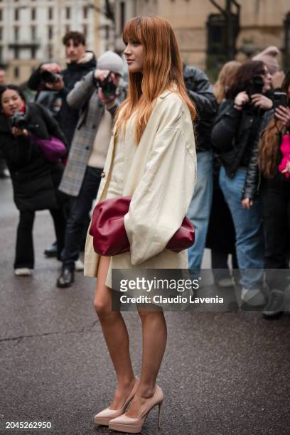 Ludovica Coscione wears cream mini dress with matching jacket, nude heels, red pouch bag, outside Philosophy, during the Milan Fashion Week -...