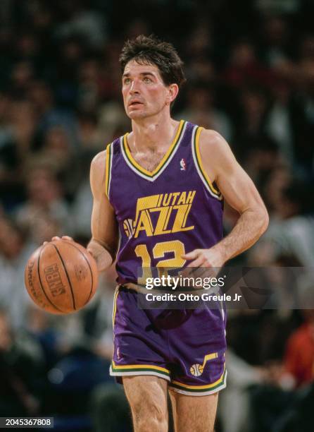 John Stockton, Point Guard for the Utah Jazz in motion dribbling the basketball down court during the NBA Pacific Division basketball game against...
