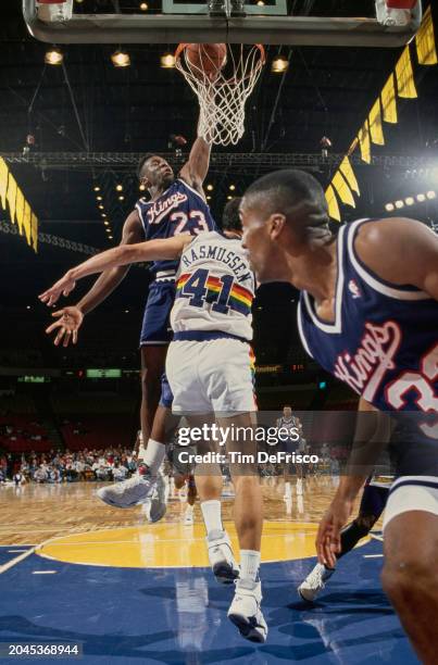 Wayman Tisdale, Power Forward for the Sacramento Kings dunks the basketball into the hoop to score during the NBA Midwest Division basketball game...