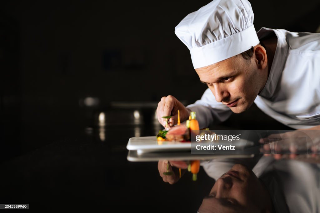 Chef decorating a plate