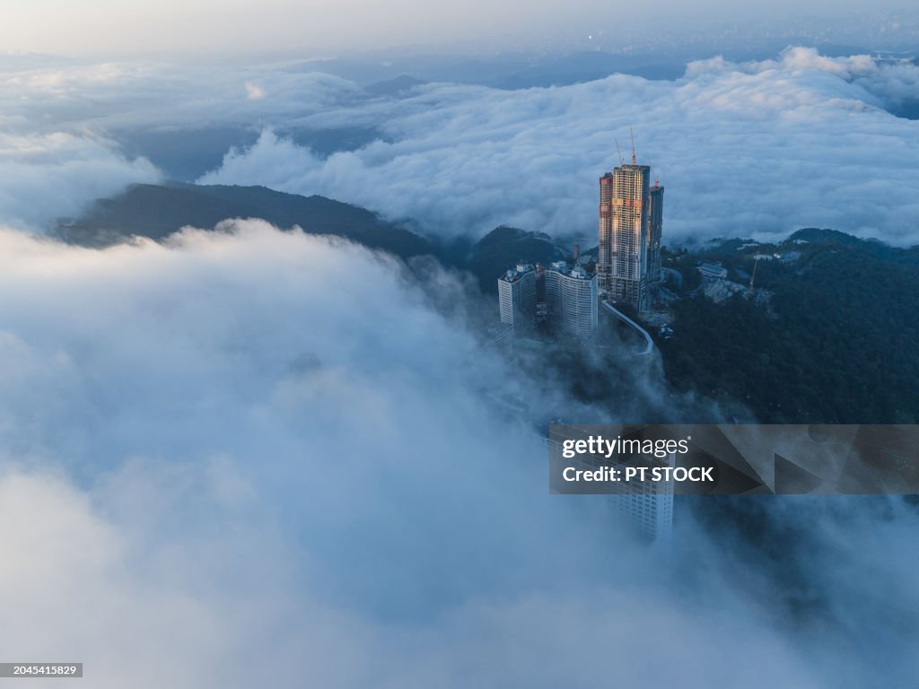 Aerial view drone A town with many tourists living among green and misty mountains, there are temples. Amusement parks and casinos bring tourists up.