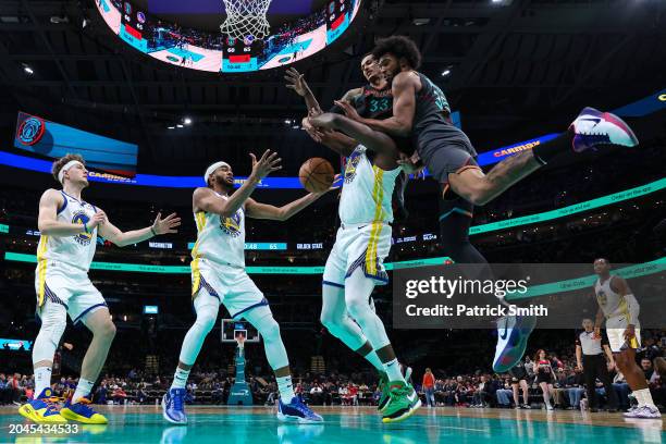 Draymond Green of the Golden State Warriors and Marvin Bagley III of the Washington Wizards battle for a rebound at Capital One Arena on February 27,...