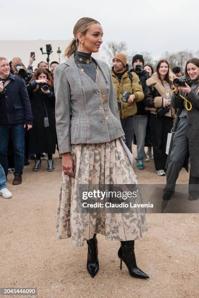 Guest wears grey turtleneck top, grey checked blazer, floral printed maxi skirt, black boots, outside Dior, during the Womenswear Fall/Winter...