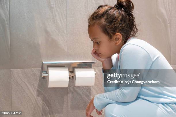the girl is sitting in the bathroom - windsor stock pictures, royalty-free photos & images