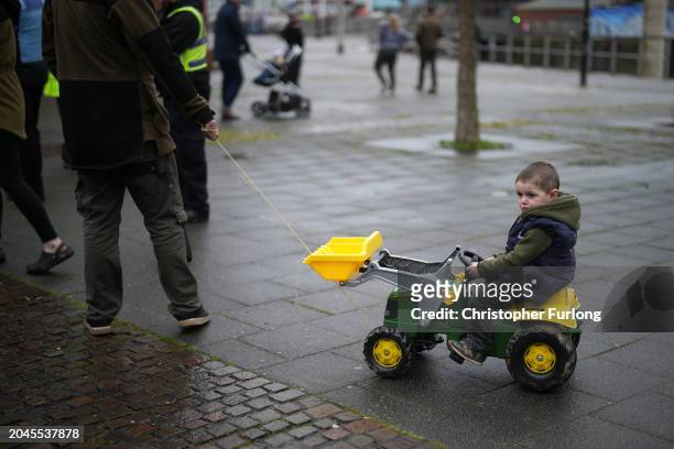 Child is pulled along on a toy tractor during protests outside the Senedd on February 28, 2024 in Cardiff, Wales. Following peaceful demonstrations...