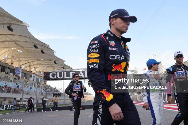 Red Bull Racing's Dutch driver Max Verstappen walks back after a group picture ahead of the Bahrain Formula One Grand Prix at the Bahrain...