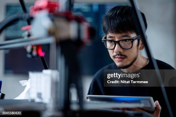 ecodesign in your product with 3d prototype and 3d printing technology. a male product designer or industrial designer use a digital tablet to check printed of new product prototype in a modern office. - intellectual property business stock pictures, royalty-free photos & images