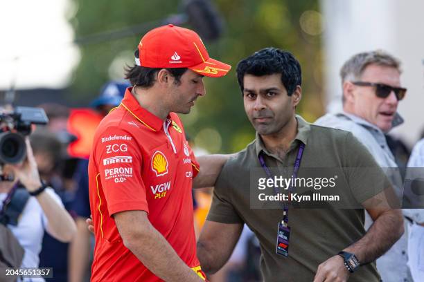 Carlos Sainz of Spain and Scuderia Ferrari speaks with former professional driver Karun Chandhok in the paddock during previews ahead of the F1 Grand...