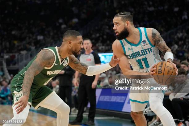 Damian Lillard of the Milwaukee Bucks defends Cody Martin of the Charlotte Hornets during the first half at Fiserv Forum on February 27, 2024 in...