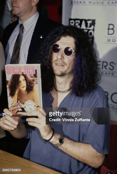 American radio host and 'shock jock' Howard Stern, wearing a blue polo shirt and sunglasses, attends a signing session for his book 'Miss America',...