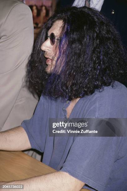 American radio host and 'shock jock' Howard Stern, wearing a blue polo shirt and sunglasses, attends a signing session for his book 'Miss America',...