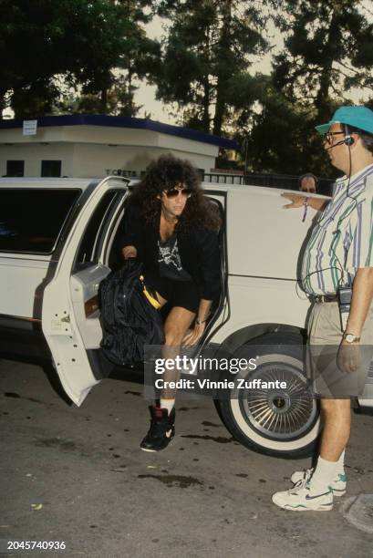 American radio host and 'shock jock' Howard Stern, wearing a black shirt over a black t-shirt with a skull-and-crossbones motif, black shorts and...