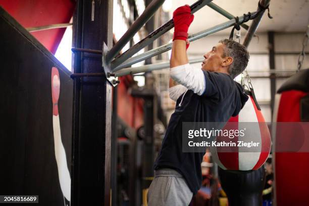 boxer working out at the gym, doing pull-ups - ups stock pictures, royalty-free photos & images