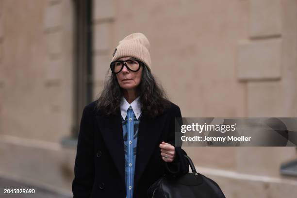 Guest seen wearing Louis Vuitton beige wool knit logo beanie, black glasses, blue / black striped print pattern buttoned shirt with white collar,...