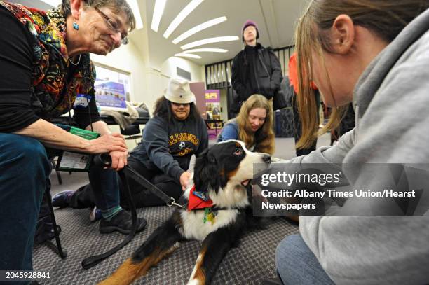From left, Happy Scherer of Delmar shares the love of her Bernese Mountain Dog Oliver with UAlbany students Violeta Loarca of Fallsburg, Larissa Ryan...