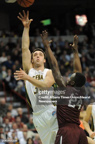 Siena's Brett Bisping goes up for a layp against Fordham's Bryan Smith during a basketball game at the Times Union Center on Monday, Dec. 30, 2013 in...